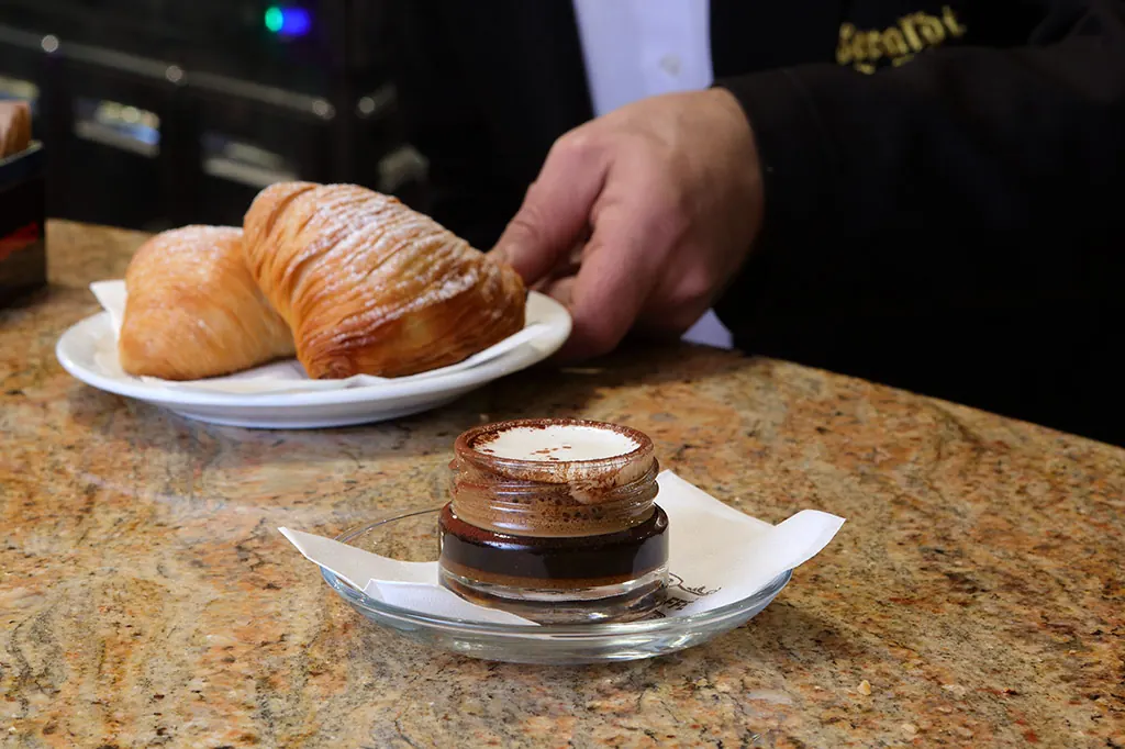 Cornetti e caffè serviti sul bancone di marmo di Ceraldi Caffè